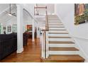 Bright, open foyer features hardwood floors, staircase with white risers, and an open view to the living room at 34 Johnston Nw Row, Cartersville, GA 30121