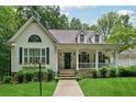 Beautiful home featuring a welcoming front porch, well-kept lawn, stone accents, and decorative shutters at 34 Johnston Nw Row, Cartersville, GA 30121