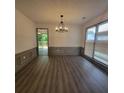 Elegant dining room with wood floors, wainscoting, modern lighting, and access to deck at 3045 Binghampton Ln, Lawrenceville, GA 30044