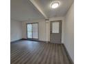 Bright living room featuring wood flooring, neutral paint, and exterior access at 3045 Binghampton Ln, Lawrenceville, GA 30044