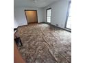 Open-concept living room with hardwood floors and large windows at 6005 Hendrix Rd, Cumming, GA 30040
