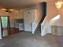 Open-concept with hardwood and carpet flooring, and a staircase at 7472 Woods Ct, Lithonia, GA 30058