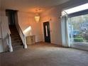Spacious living room featuring a chandelier and staircase at 7472 Woods Ct, Lithonia, GA 30058