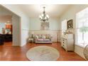 Comfortable living room features hardwood floors, neutral decor, and is ready for entertaining or relaxing at 1404 Fairwinds Ct, Loganville, GA 30052