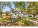 Beautiful home with gray siding, lush green grass, a quaint walkway, and mature trees at 1471 Hardin Dr, College Park, GA 30337
