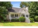 Attractive home with a front porch and well-kept lawn, surrounded by lush greenery at 6280 Autry Mill Rd, Cumming, GA 30028