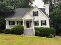 Charming two-story home with white siding, black shutters, a well-manicured lawn, and inviting front porch at 6280 Autry Mill Rd, Cumming, GA 30028