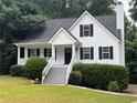 Charming two-story home with white siding, black shutters, a well-manicured lawn, and inviting front porch at 6280 Autry Mill Rd, Cumming, GA 30028
