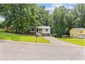 Charming home featuring a welcoming porch, two car garage and mature trees at 6441 Michell Way, Douglasville, GA 30135