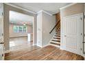 Welcoming foyer with hardwood floors, staircase, and an open view to the living area at 1858 Belmore Se St, Smyrna, GA 30080