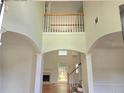 Grand foyer with soaring ceilings, archways, and staircase leading to the second floor at 2670 Henderson Chase Ct, Tucker, GA 30084
