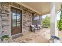 Inviting front porch with stone flooring, stylish seating, and decorative accents at 5960 Overlook Club Cir, Suwanee, GA 30024