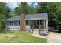 Attractive single-story house with a brick chimney and welcoming front porch at 2039 Gober Ave Se, Smyrna, GA 30080