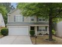 Charming two-story home with a well-maintained lawn, a two-car garage, and tasteful landscaping at 3347 Sable Run Rd, Atlanta, GA 30349