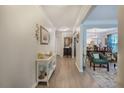 Bright hallway featuring hardwood floors, decorative ceiling, and views of the living and dining rooms at 3347 Sable Run Rd, Atlanta, GA 30349
