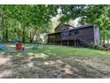 Private backyard with a fire pit, outdoor seating, and a spacious deck for entertaining guests at 3470 Hill Ln, Acworth, GA 30102