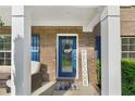 Inviting front porch with seating, brick accents, and a charming blue front door, adorned with a 'Welcome' wreath at 109 Hale View Cir, Canton, GA 30114
