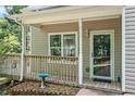 Cozy front porch with a wooden deck and railings, offering a welcoming entrance to the home at 3255 Marine Rd, Cumming, GA 30041