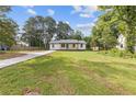 Charming single-story home featuring a lovely front porch, a well-maintained lawn and updated landscaping at 2310 Whitehead Place Dr, Suwanee, GA 30024