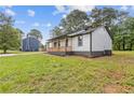 Charming single-story home featuring a lovely front porch, well-maintained lawn, and side yard at 2310 Whitehead Place Dr, Suwanee, GA 30024