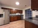 Kitchen featuring stainless steel appliances, wood cabinets, and granite countertops at 1271 Whitlock Ridge Sw Dr, Marietta, GA 30064
