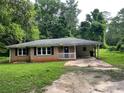Ranch style house with brick, covered porch, and covered driveway at 2369 Christian Cir, Covington, GA 30016