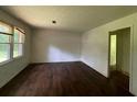 Spacious living room featuring hardwood floors, large windows, and neutral-colored walls at 2369 Christian Cir, Covington, GA 30016