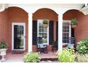Inviting front porch with rocking chairs and hanging flower baskets, perfect for relaxing outdoors at 405 Mallory Cir, Loganville, GA 30052