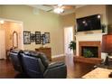 Spacious living room with a cozy fireplace, hardwood floors and plenty of natural light at 405 Mallory Cir, Loganville, GA 30052