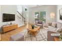 Bright, staged living room with hardwood floors and a cozy seating area at 4133 Rosedown Nw Ct, Kennesaw, GA 30144
