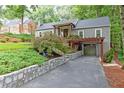 Charming home showcasing stone retaining wall and covered parking at 3072 Dale Ne Dr, Atlanta, GA 30305