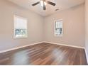Bedroom featuring a ceiling fan, light-colored walls, window blinds and hardwood floors at 7880 Rivertown Rd, Fairburn, GA 30213