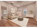 Bright living room featuring hardwood floors, recessed lighting, and a comfortable sofa at 7880 Rivertown Rd, Fairburn, GA 30213