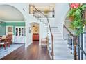 Grand two-story foyer with hardwood floors, elegant staircase, and views into the dining and living areas at 4365 Mantle Ridge Dr, Cumming, GA 30041