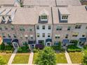 Aerial view of townhomes showcasing the rooflines, walkways, and manicured lawns at 20057 Windalier Way, Roswell, GA 30076