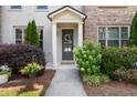 Charming front entrance with decorative door, sidelights, and well-maintained landscaping at 20057 Windalier Way, Roswell, GA 30076