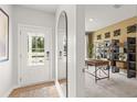 Inviting foyer with wood-look floors, a front door with glass, and a view into the home office at 2655 Mourning Dove Dr (Lot 50), Grayson, GA 30017