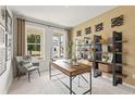 Bright home office featuring neutral paint, a large window, shelving, and a modern desk at 2655 Mourning Dove Dr (Lot 50), Grayson, GA 30017