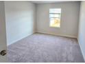 Bright bedroom with neutral carpet, ample natural light from a large window, and fresh white walls at 2665 Mourning Dove Drive(Lot 51), Grayson, GA 30017