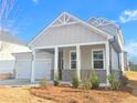 Charming home with a covered porch, showcasing brick accents and a well-maintained lawn at 2665 Mourning Dove Drive(Lot 51), Grayson, GA 30017