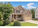 Inviting two-story home with a blend of brick and siding, complemented by a well-kept lawn and cozy front porch at 432 Providence Walk St, Canton, GA 30114