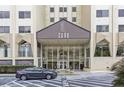 Exterior view of Park Lane entry, showcasing modern architectural design, glass facade, and parking at 2479 Peachtree Ne Rd # 301, Atlanta, GA 30305