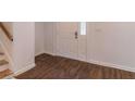 Inviting entryway boasts wood-look tile floors and a bright white front door with glass inserts at 4408 Shiloh Trl, Powder Springs, GA 30127