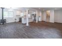 Spacious living room boasts wood-look floors, modern kitchen, and staircase access at 4408 Shiloh Trl, Powder Springs, GA 30127