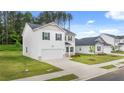 A view of a two-story home with a two-car garage and manicured front lawn at 1622 Palladian Way, Lithonia, GA 30058