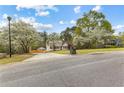 Scenic view of property surrounded by trees, long driveway, and manicured front yard at 195 Blackberry Run, Fayetteville, GA 30214