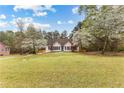 Traditional home featuring well-maintained front lawn and mature trees at 195 Blackberry Run, Fayetteville, GA 30214