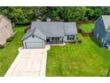 Aerial view of a well-maintained home with a green lawn and mature trees at 314 Spring Falls Drive, Lawrenceville, GA 30045