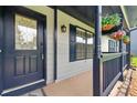 Close-up of the front porch featuring flower baskets and dark blue trim at 314 Spring Falls Drive, Lawrenceville, GA 30045