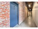 Hallway with exposed brick walls, concrete floors, and modern lighting fixtures at 320 Martin Luther King Jr Se Dr # 9, Atlanta, GA 30312